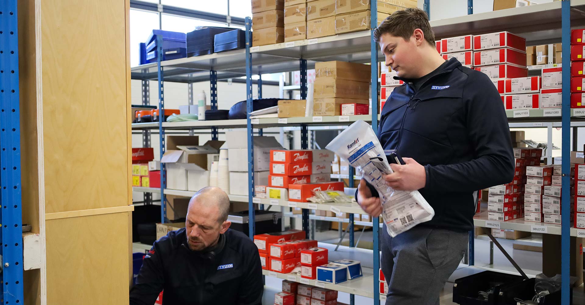 To medarbejdere på STYREGS lager, der finder produkter fra hylderne